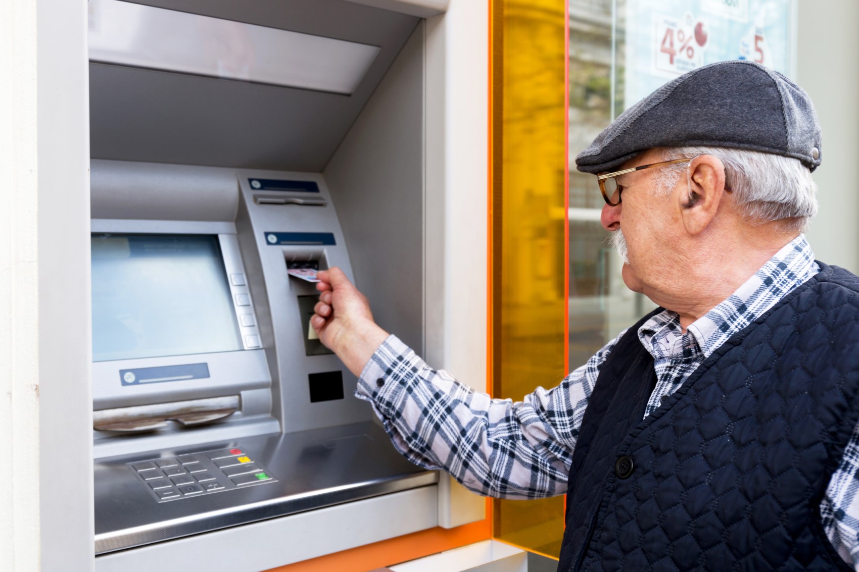 084409087-older-man-using-atm.jpg